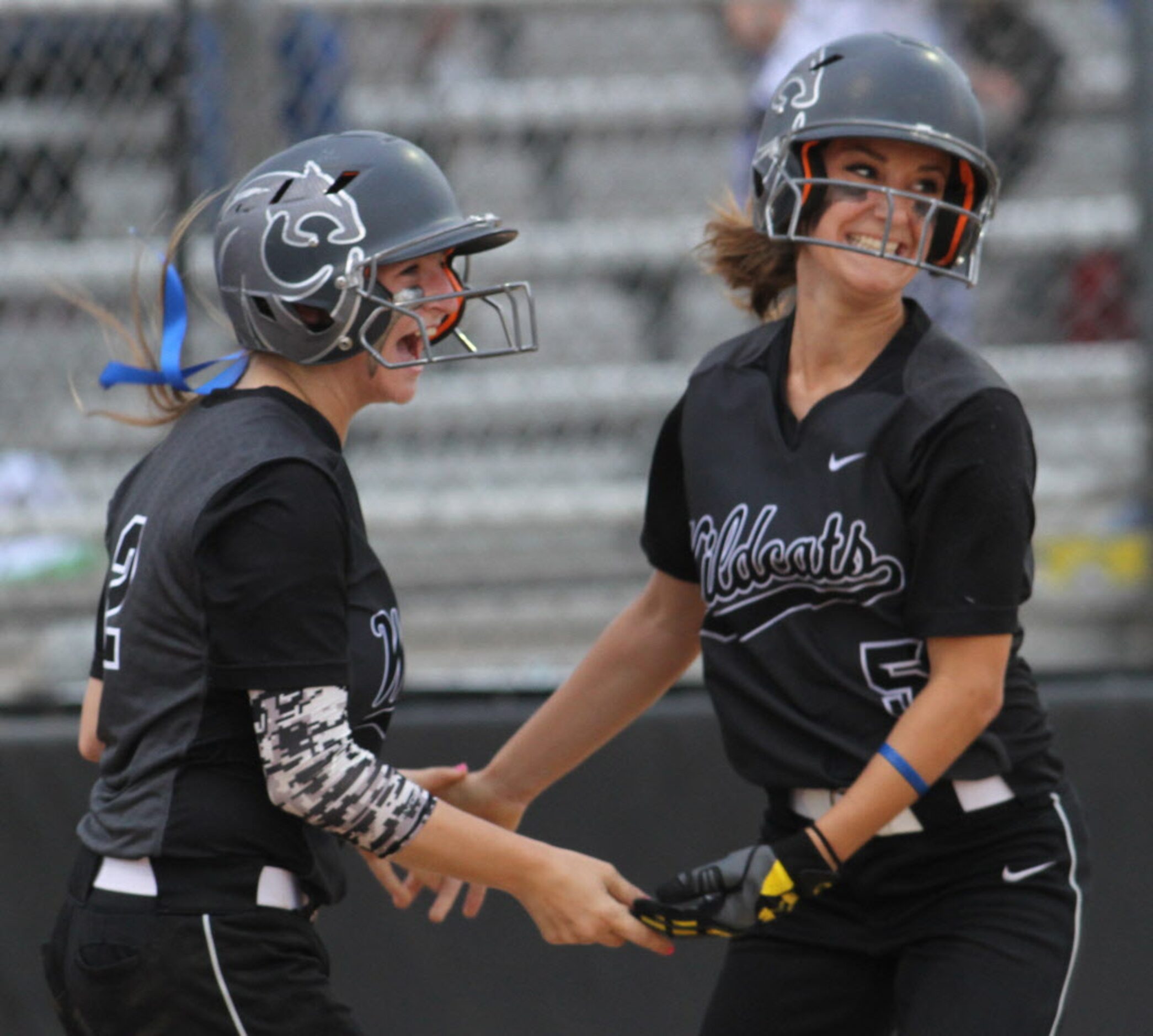 Denton Guyer teammates Avery Williams (5) and Riley Oldham (2) celebrate at home plate after...