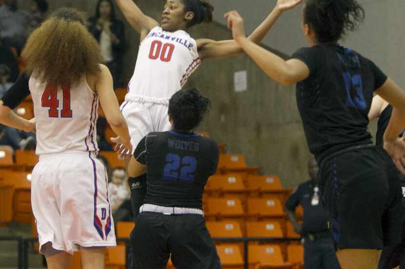 Duncanville guard Zarielle Green (00) goes above and beyond as she leaps from a crowd of...