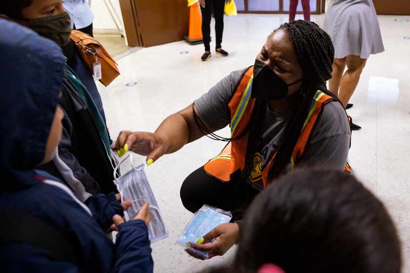 Principal Shanieka Christmas-McDonald hands out masks during the first day of school on...