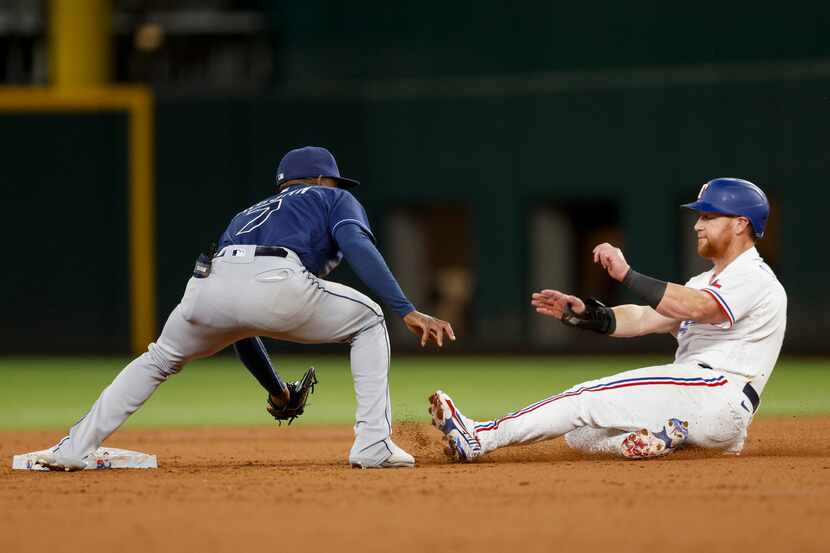 Texas Rangers right fielder Kole Calhoun (56) is caught stealing at second base by Tampa Bay...