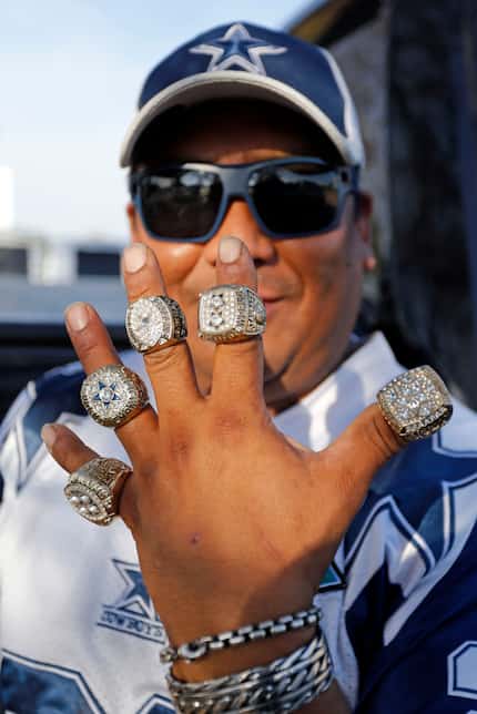 Dallas fan Silverio Delgado, displays his Super Bowl Ring reproductions while tailgating at...