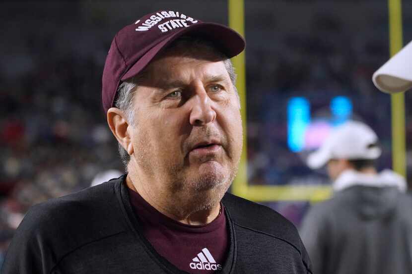 Mississippi State coach Mike Leach talks with Mississippi coach Lane Kiffin before an NCAA...