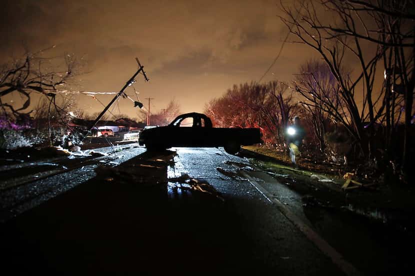 A heavily damaged and abandoned pickup sat on Schrade Road in Rowlett after a tornado ripped...