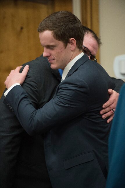 John R.K. Howard (right) embraces defense attorney Ira Dillman after his sentencing hearing...