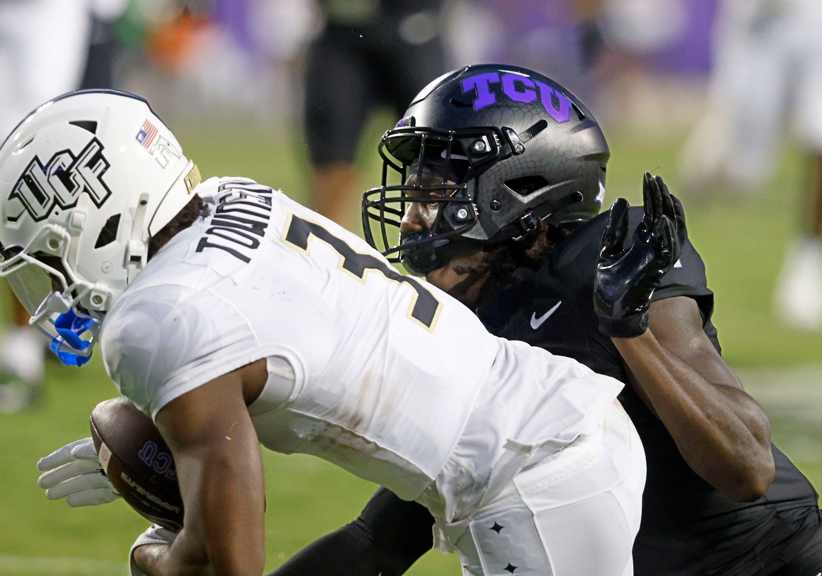 UCF wide receiver Xavier Townsend (3) is tackled by TCU safety Abe Camara (1) during the...