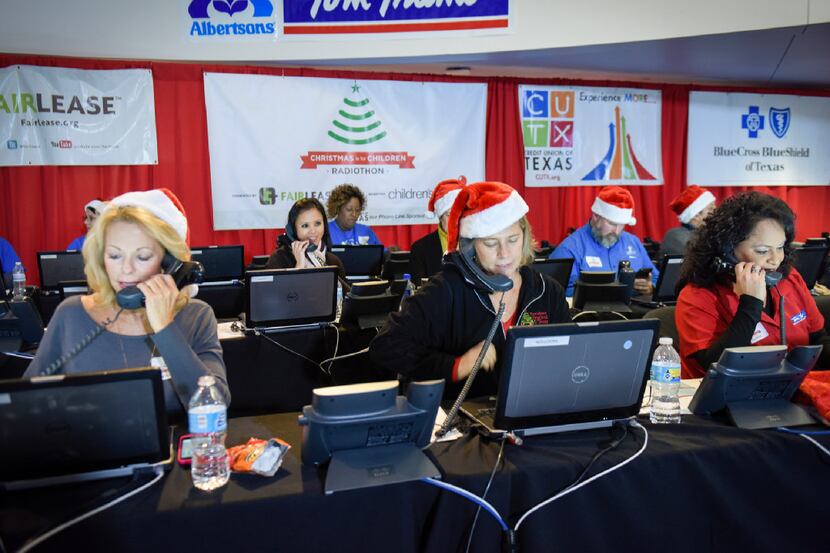 Blue Cross Blue Shield volunteers on the phones taking donations during the Christmas is for...
