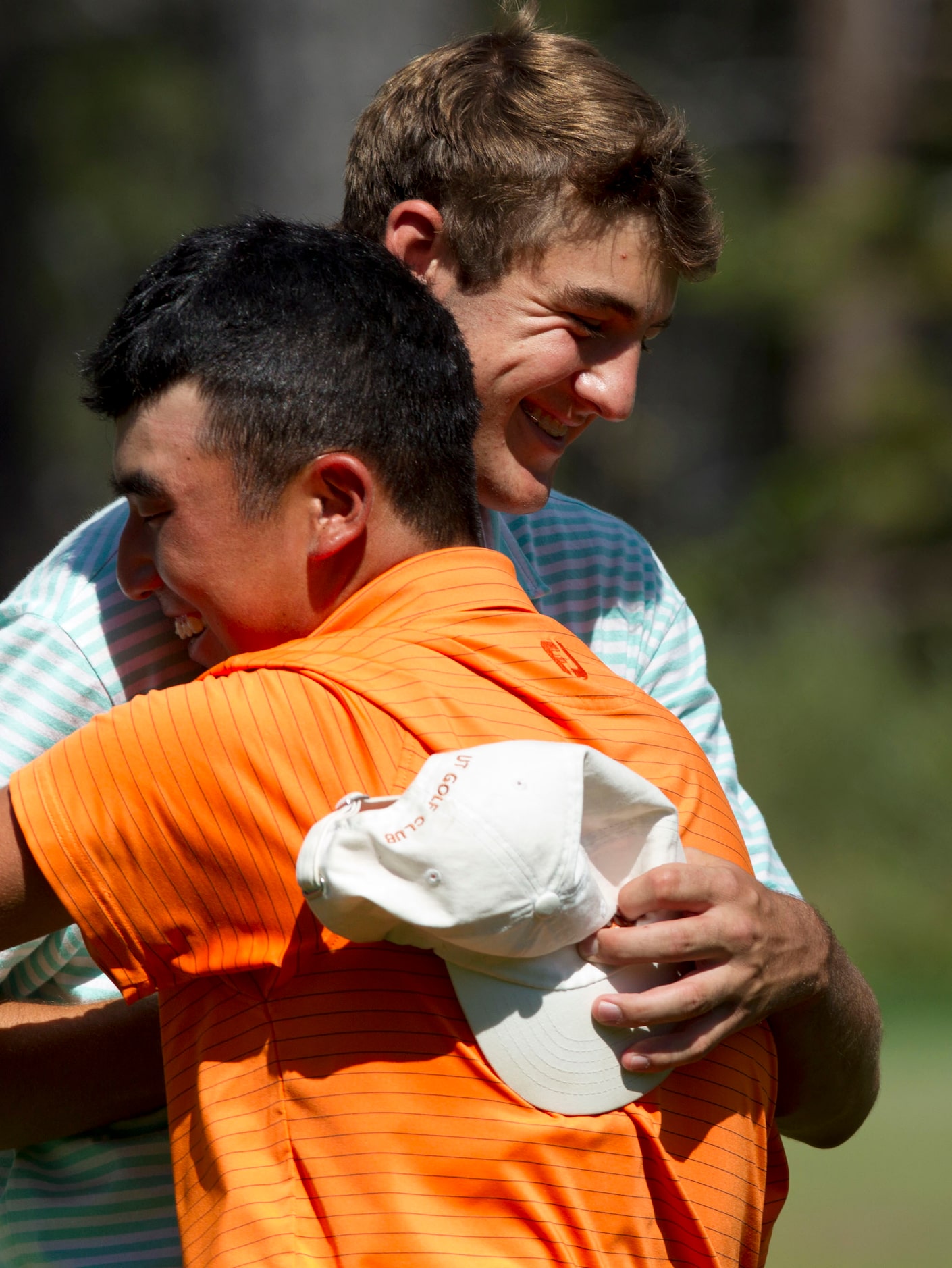 Scottie Scheffler is embraced by Doug Ghim following his 6and4 win at the 14th hole during...