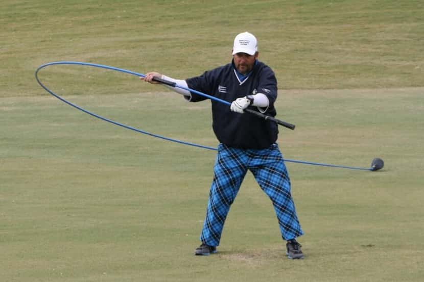 Michael Furrh of Arlington practices with his 30-foot, 6-inch driver, which he used to set a...