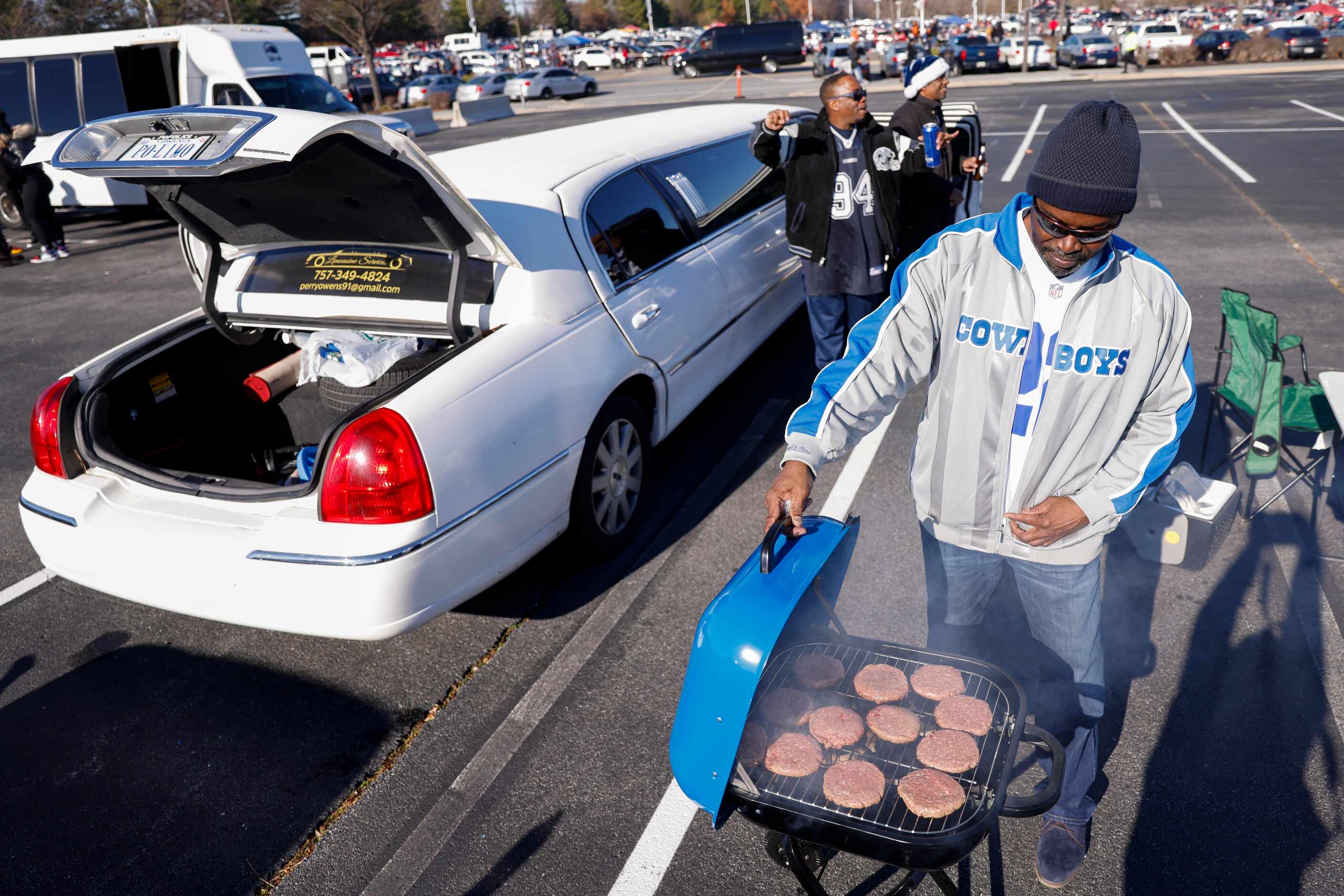 James Cofa of Virginia Beach, VA grills before the start of an NFL game between the Dallas...