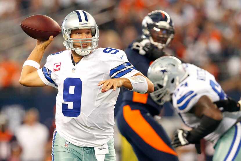 Dallas Cowboys quarterback Tony Romo watches as Caleb Hanie throws a pass during an NFL...