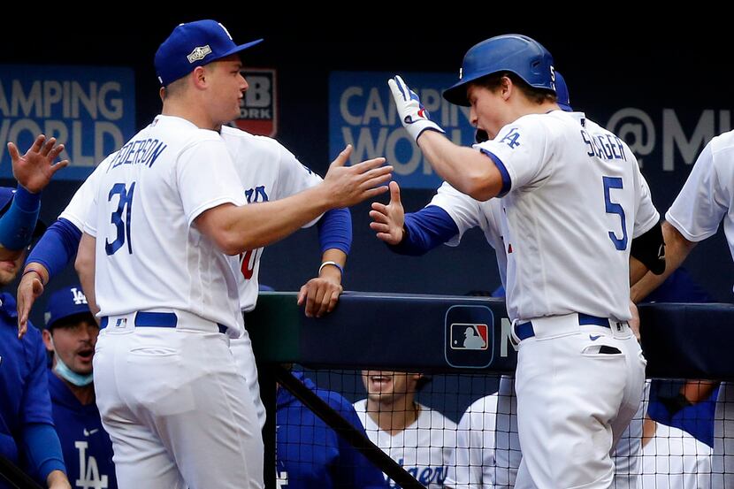 Los Angeles Dodgers shortstop Corey Seager (5)  is congratulated on his first inning solo...