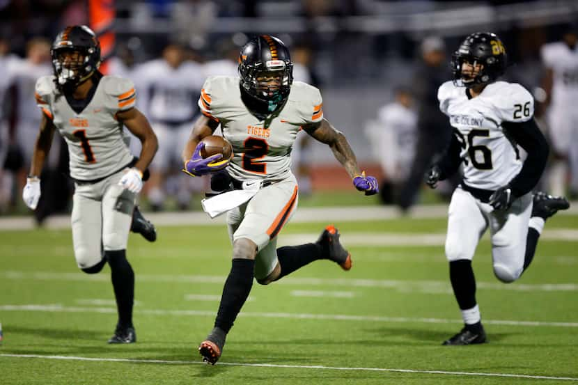 Lancaster running back Tre Bradford (2) runs away from The Colony's Jose Escobedo (26) for a...