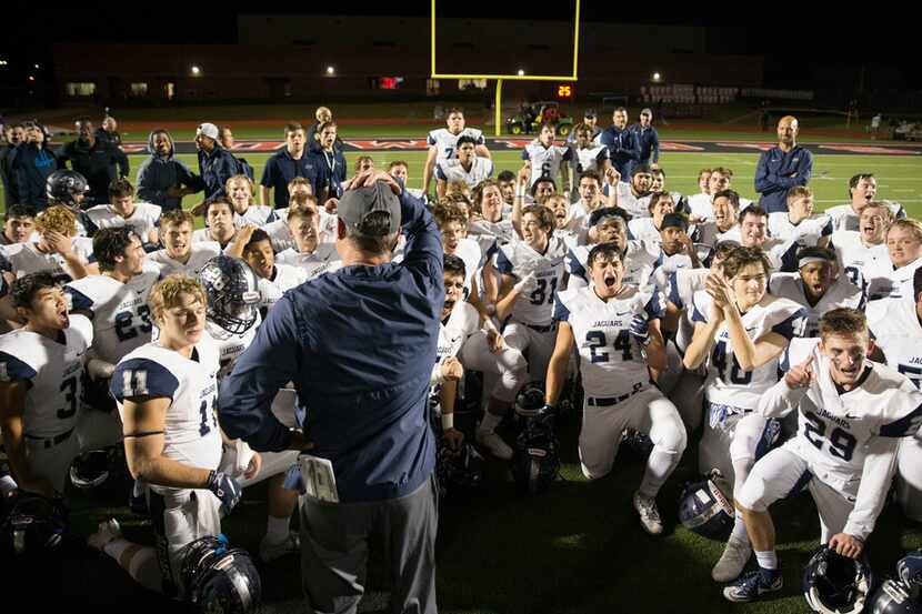 After looking at the final score, the Flower Mound Jaguars celebrate their victory against...