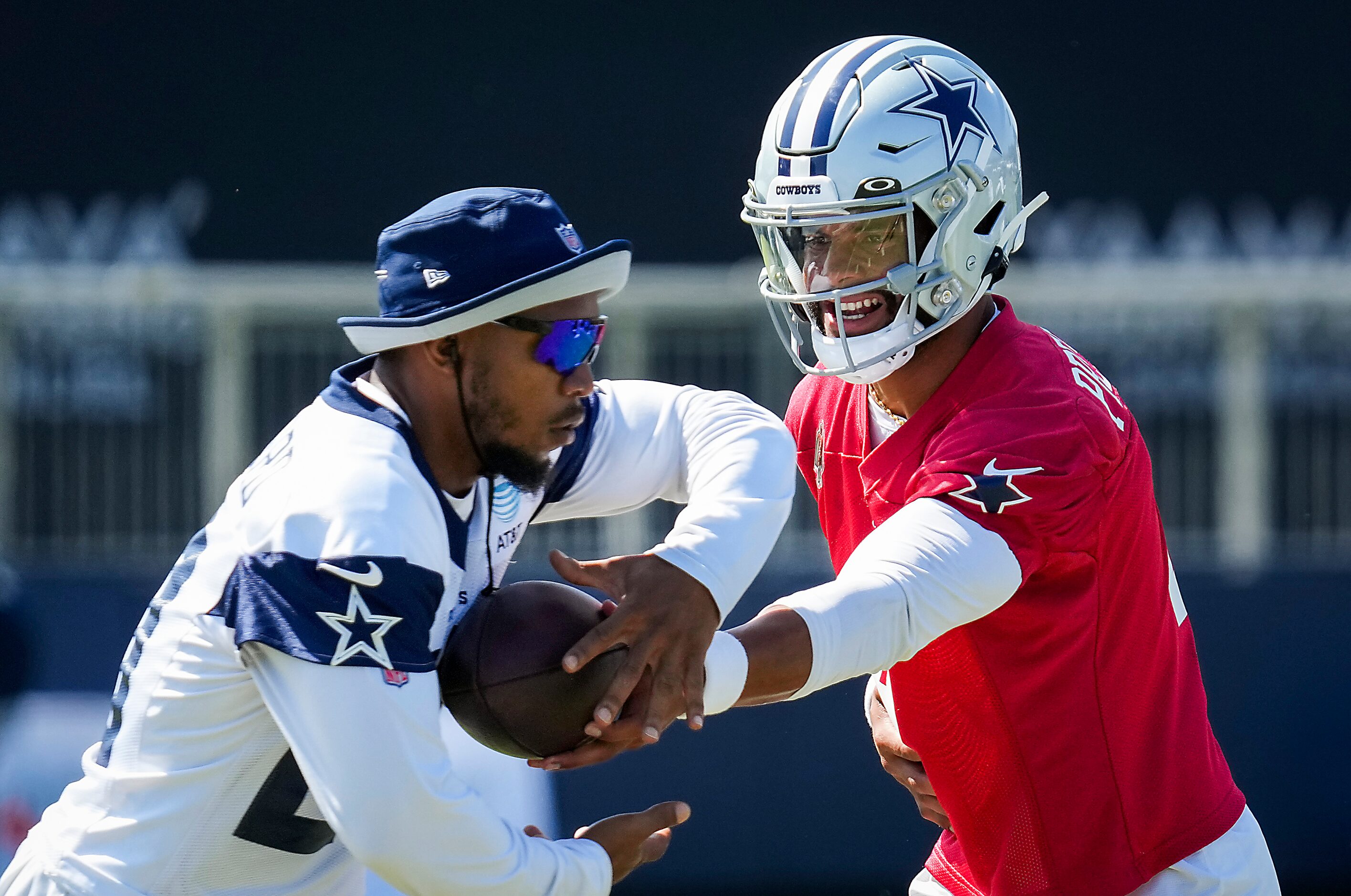 Dallas Cowboys quarterback Dak Prescott (4) hands the ball off to running back Tony Pollard...