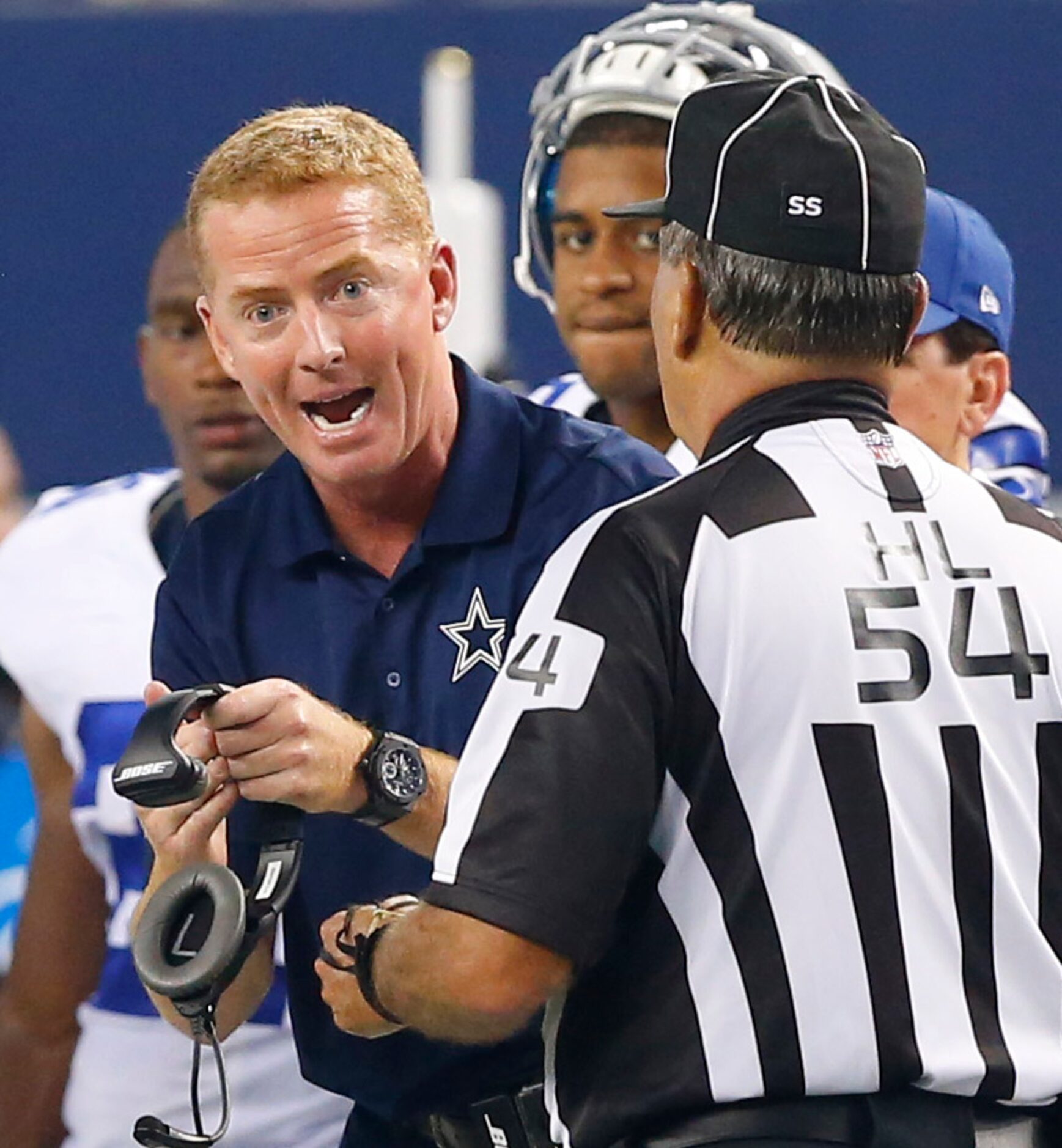 Dallas Cowboys head coach Jason Garrett argues with head linesman George Hayward (54) in the...