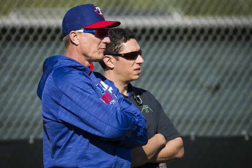 Texas Rangers General Manager Jon Daniels (left) and manager Jeff Banister watch pitchers...