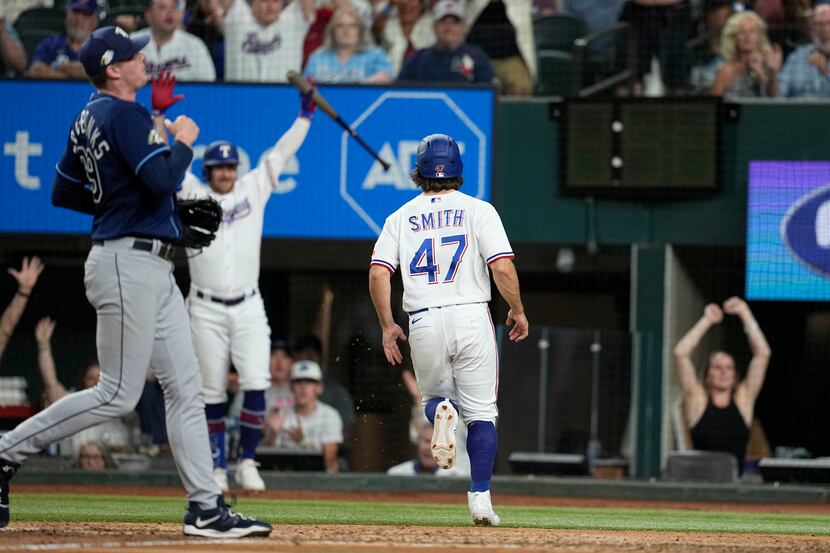 Texas Rangers' Josh Smith (47) crosses home plate after scoring on a wild pitch by Tampa Bay...