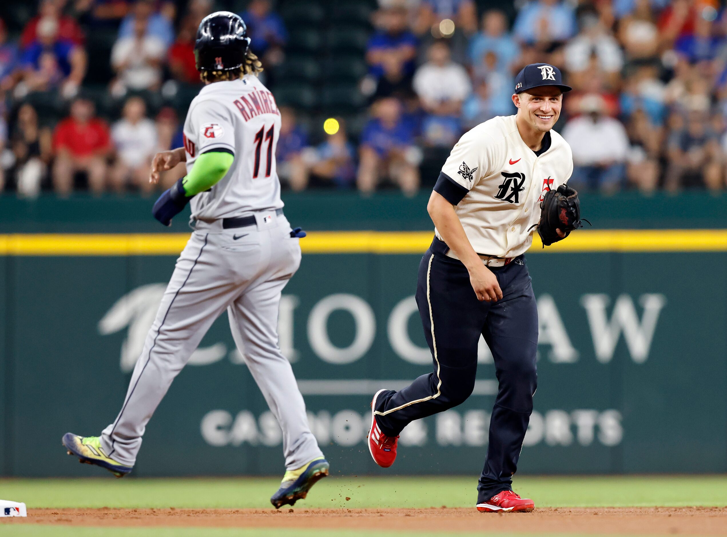 Texas Rangers shortstop Corey Seager (5) laughs after realizing he could have stepped on the...