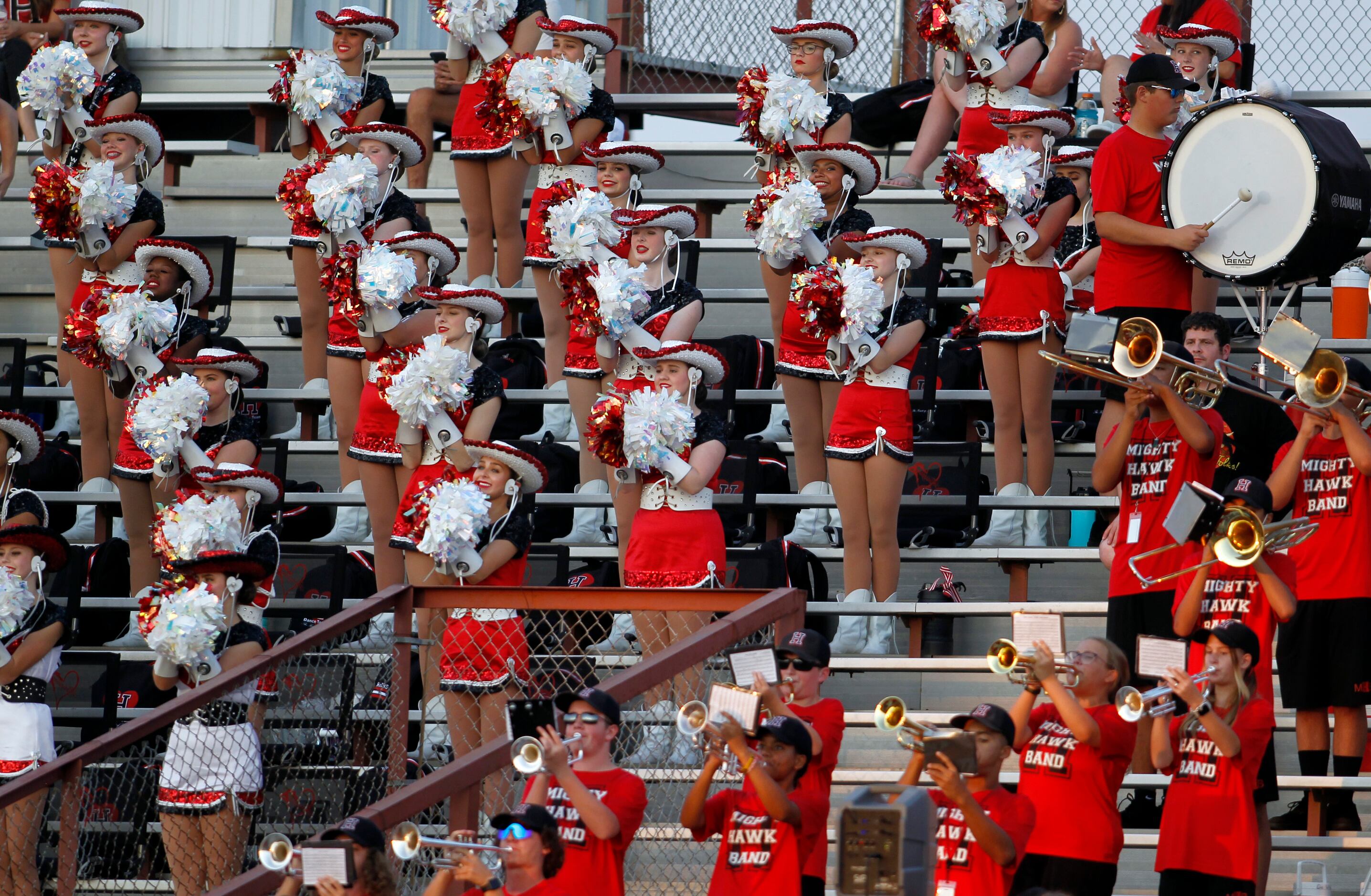 Rockwall Heath band and drill team members perform from the stands during first quarter...