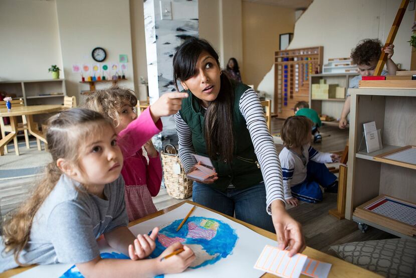 Kanan Patel, a teacher at the Aster Montessori School in Cambridge, Mass., with students, in...