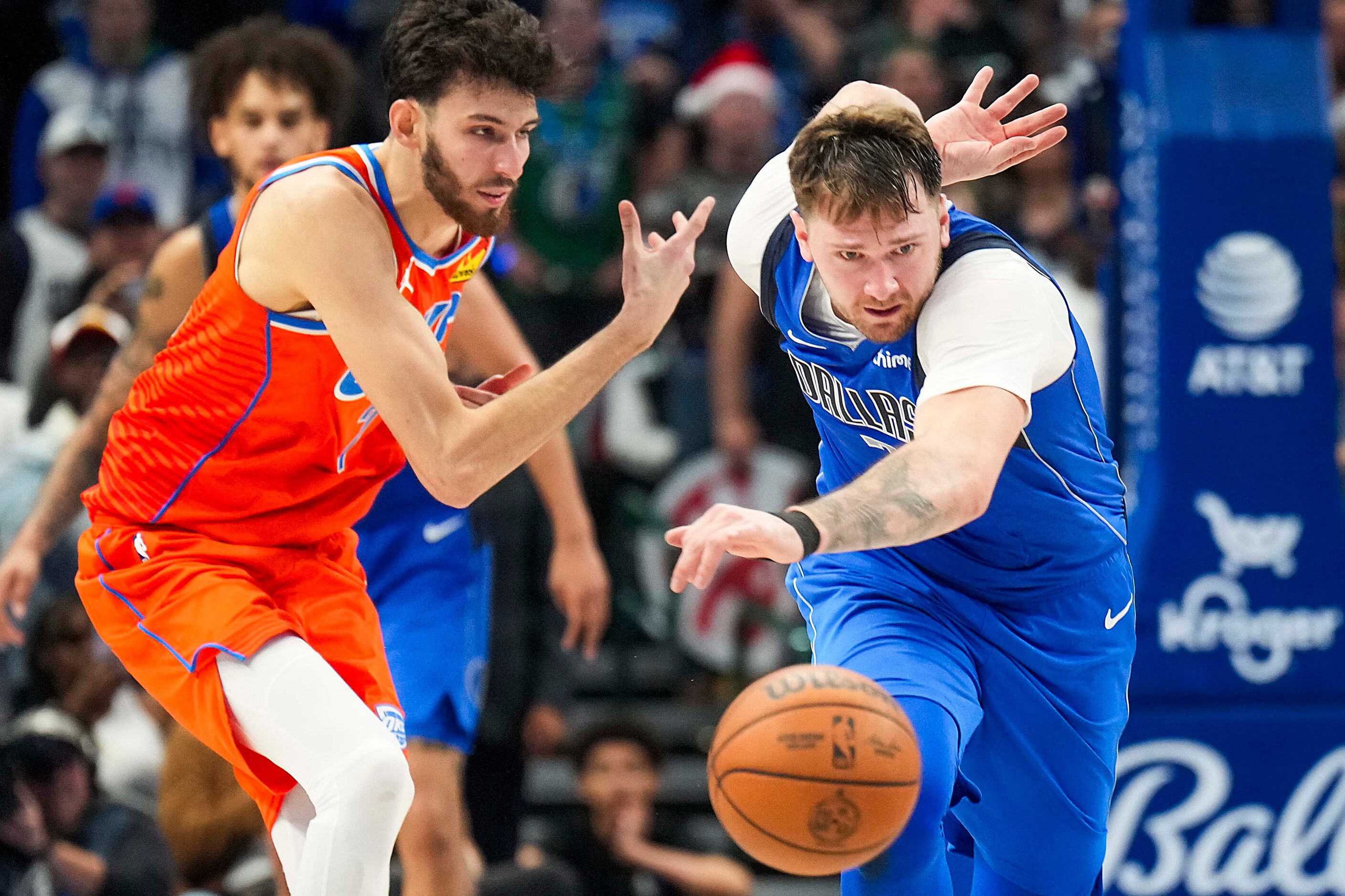 Dallas Mavericks guard Luka Doncic (77) steals the ball from Oklahoma City Thunder forward...