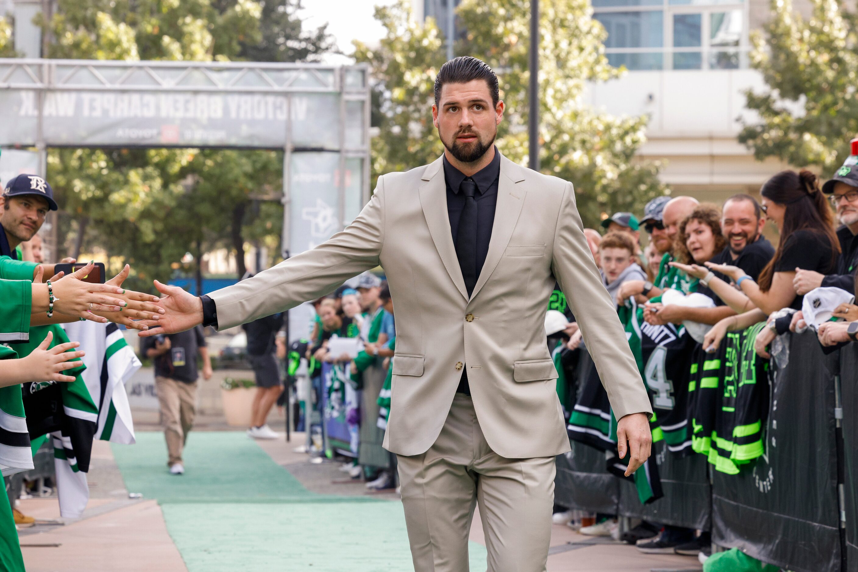 Dallas Stars left wing Jamie Benn high-fives fans on the green carpet to the American...