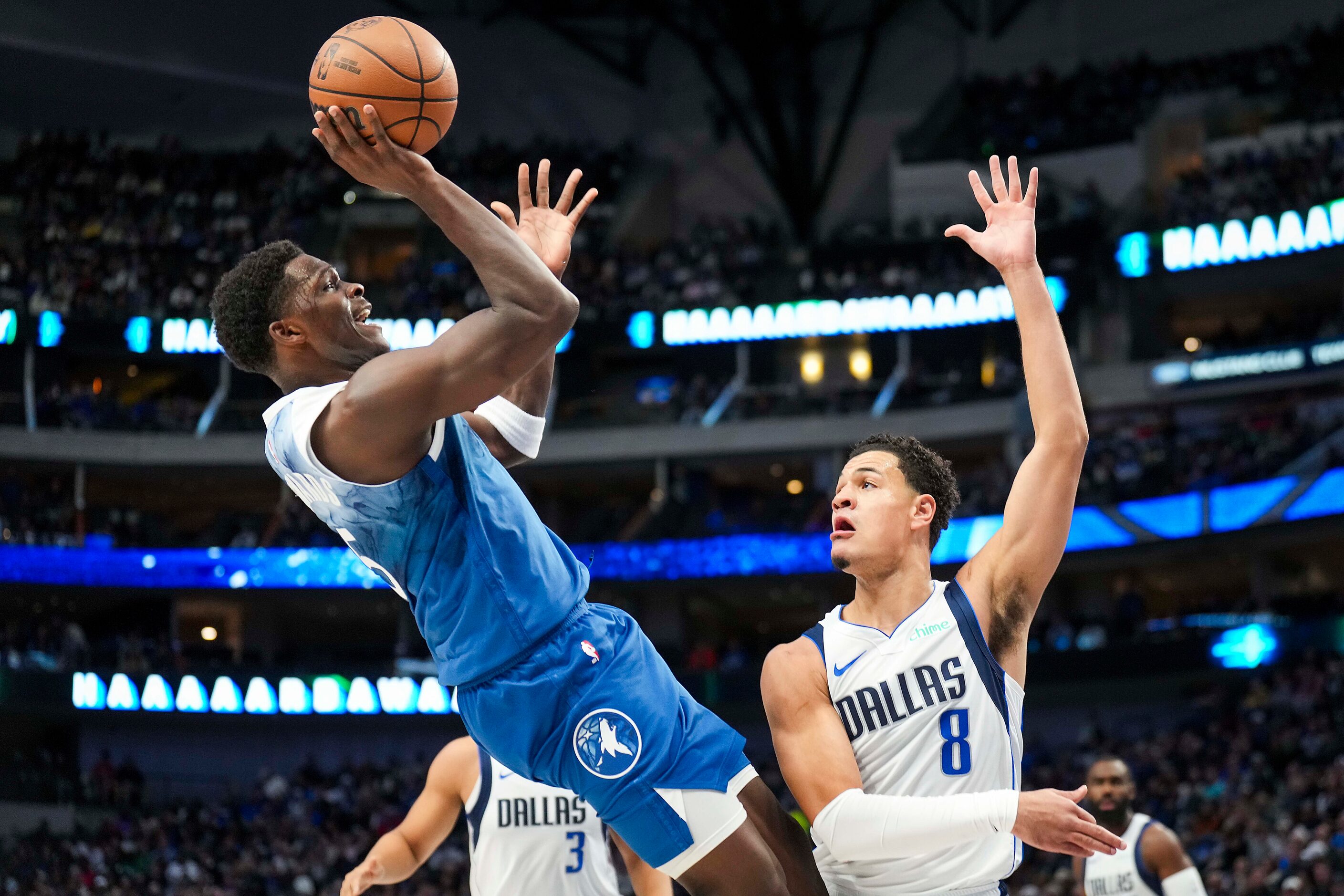 Minnesota Timberwolves guard Anthony Edwards (5) shoots over Dallas Mavericks guard Josh...