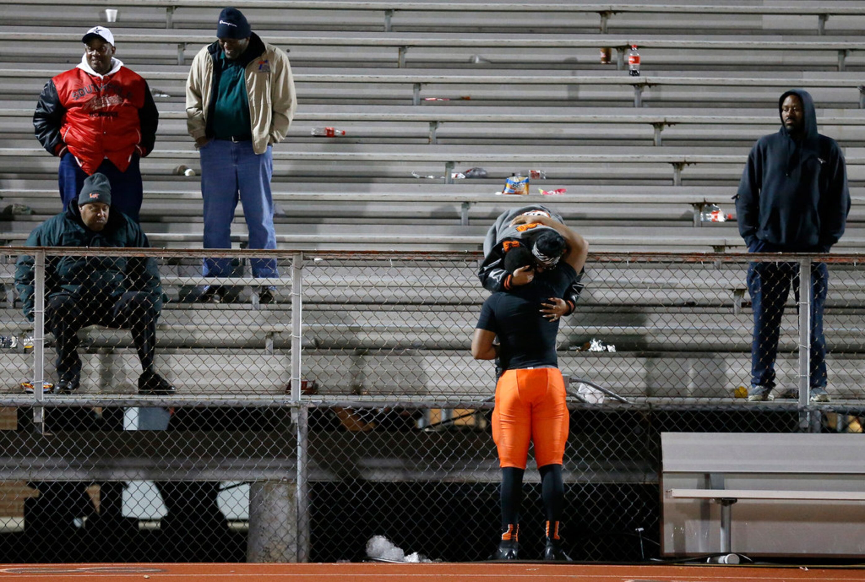 Lancaster defensive back Andre Dibbles Right) receives a hug following their loss too Frisco...