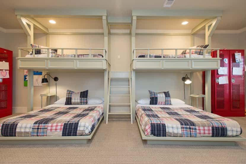 A pair of bunk beds constructed for young grandchildren is divided by ship ladder stairs and...