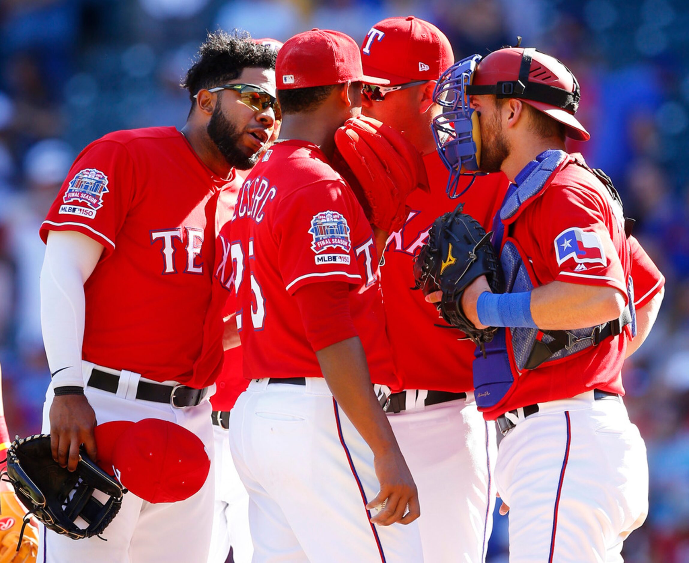 Texas Rangers relief pitcher Jose Leclerc (25) receives an earful from shortstop Elvis...