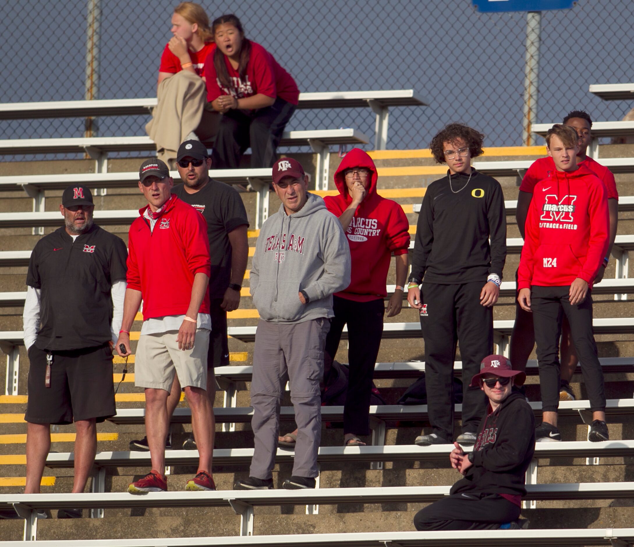 A group of fans follow the action during a relay event. The  Class 6A Region 1 and Class 5A...