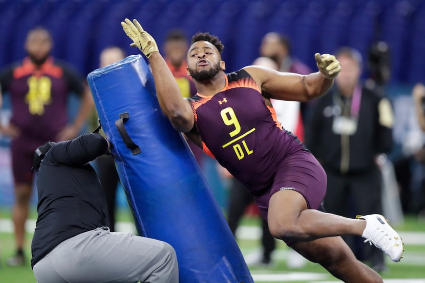 Texas A&M defensive lineman Kingsley Keke runs a drill at the NFL football scouting combine...