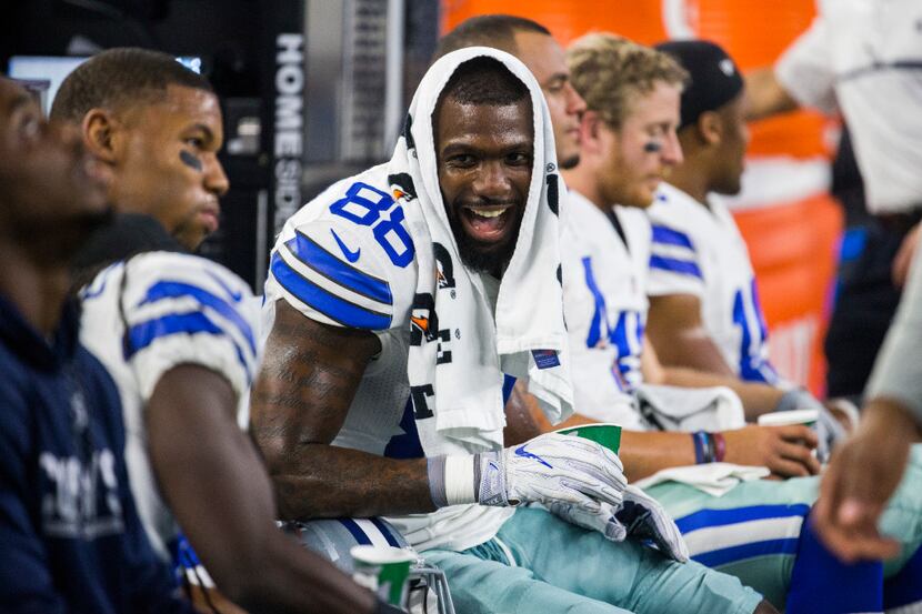Dallas Cowboys wide receiver Dez Bryant (88) celebrates a touchdown on the bench with team...