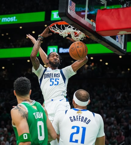 Dallas Mavericks forward Derrick Jones Jr. (55) dunks the ball as center Daniel Gafford (21)...