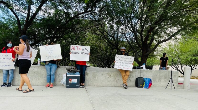 A small group of protesters stood outside federal court in El Paso calling for the end of...