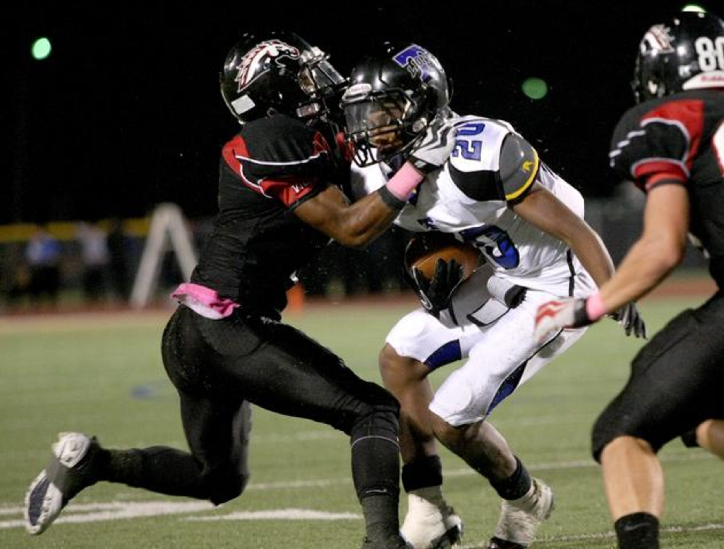 Creekview senior defensive back Bobby Kennedy, left, takes down R.L. Turner's junior wide...