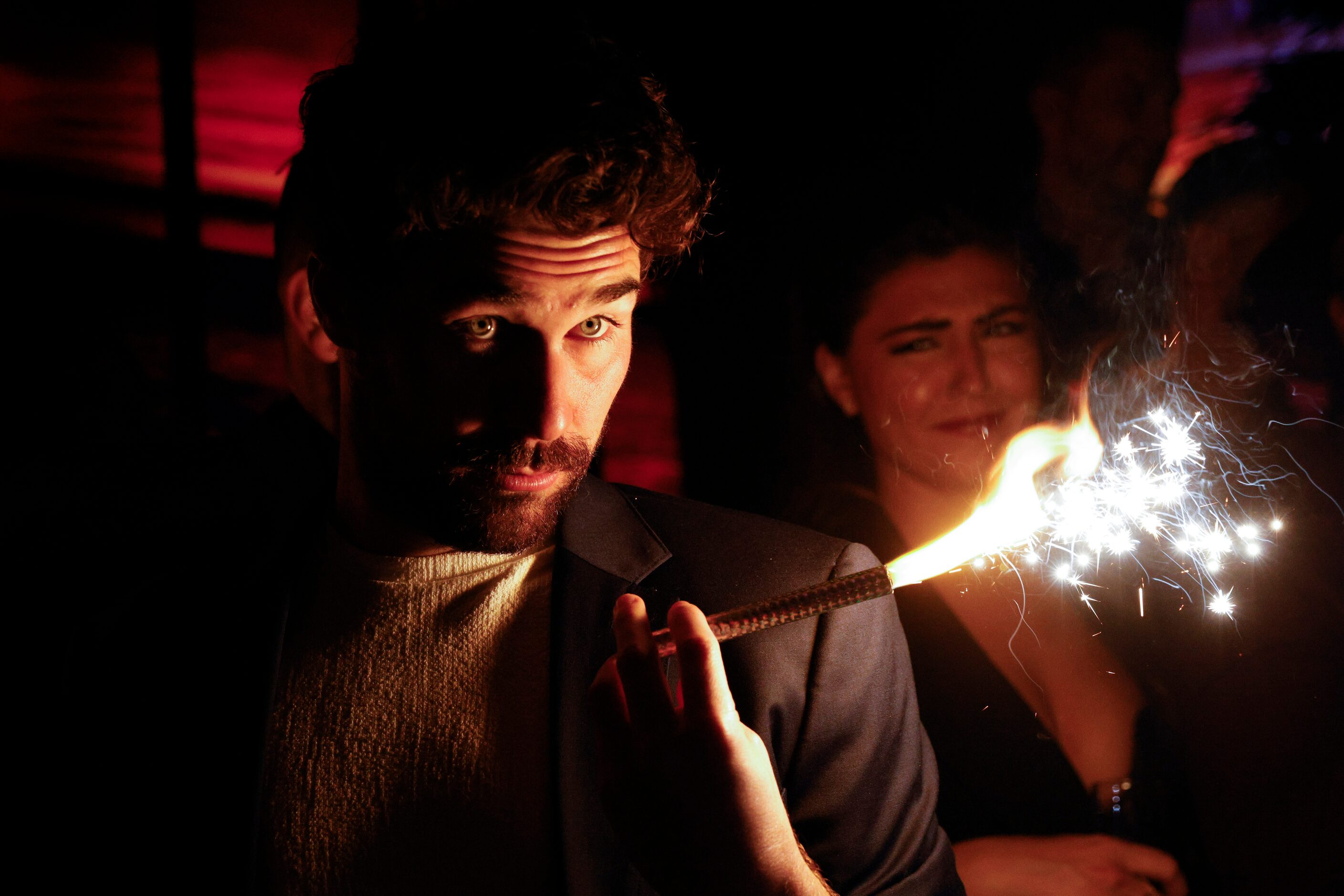 Love is Blind cast member Cole Barnett holds a sparkler during a watch party for the...