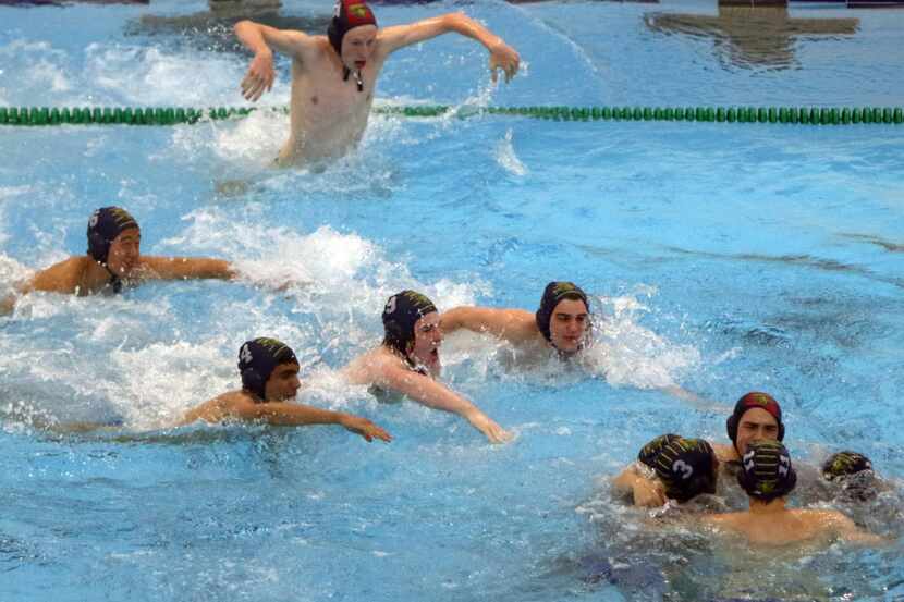 FILE - The bench cleared as water polo team members from St. Mark's joined the others in the...