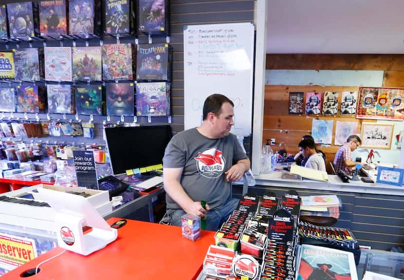 
Red Pegasus Games & Comics co-owner Kenneth Denson watches participants at the Magic The...