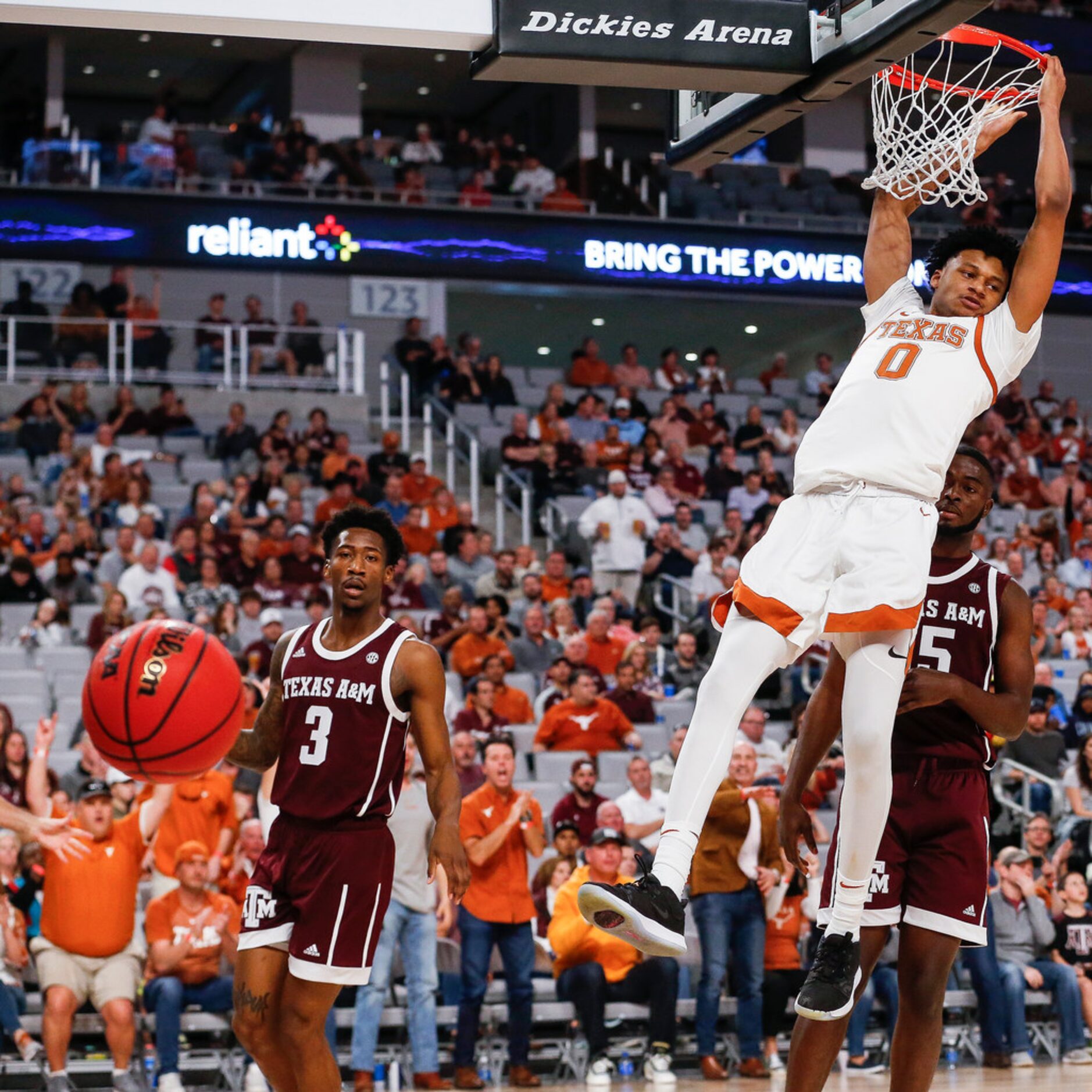 Texas Longhorns forward Gerald Liddell (0) dunks over Texas A&M Aggies guard Quenton Jackson...