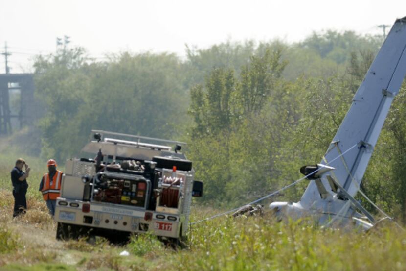 Investigators worked the scene of a plane crash in Carrollton on Monday.