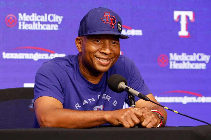 Texas Rangers third base coach Tony Beasley smiles as he listens to a question during a...