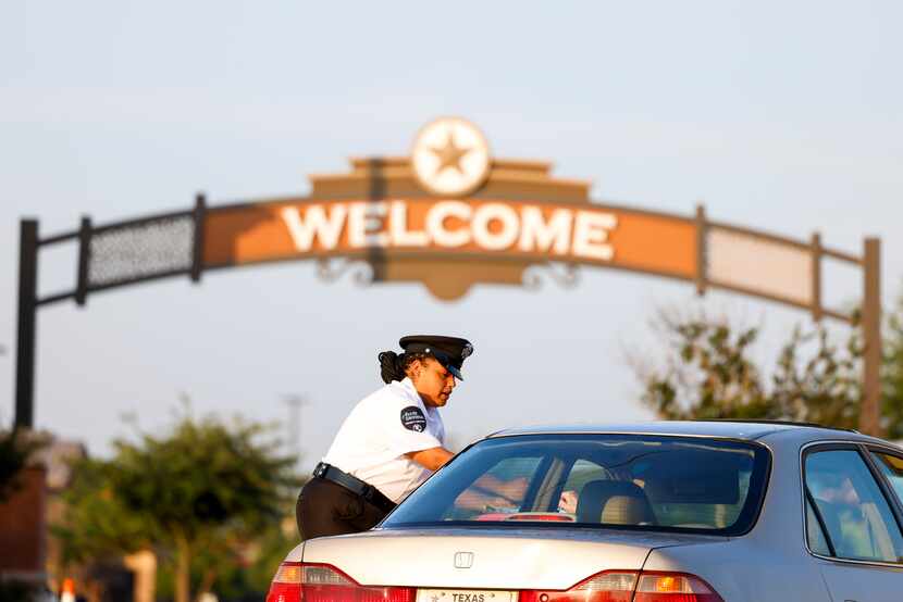 A security guard assisted a motorist outside the north entrance of Allen Premium Outlets...