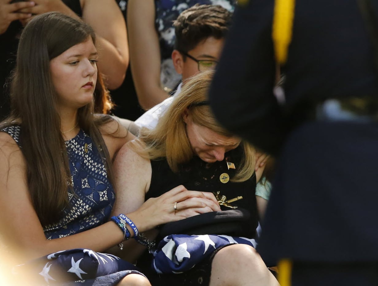 Heidi Smith, wife of slain Dallas police Sgt. Michael Smith, is overcome with emotion as she...