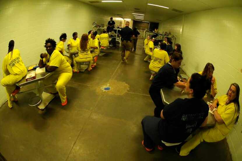 
Guards walked through a dormatory cell housing female inmates at the Nacogdoches (Texas)...