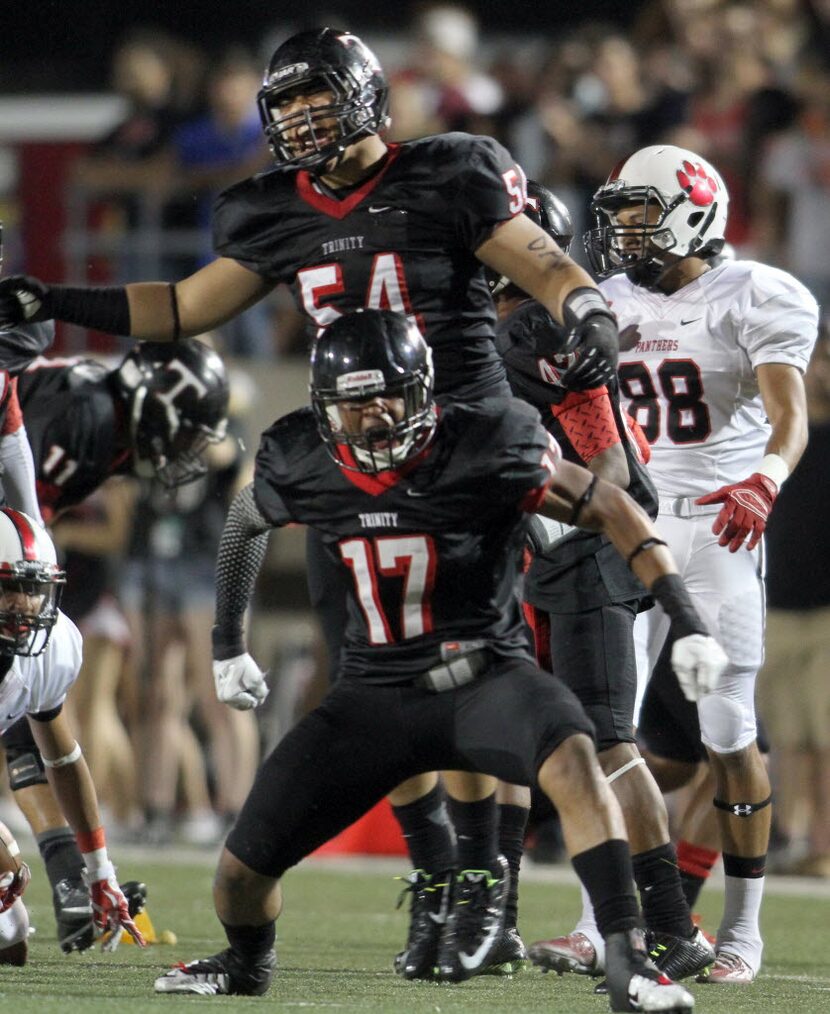 Euless Trinity defensive back TJ Kautai (17) and defensive lineman Viliami Finau (54)...