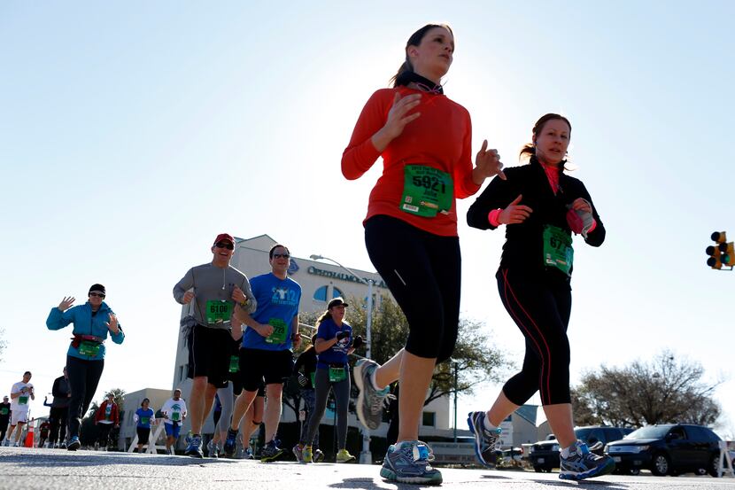 Marathon runners run the course of the Cowtown Marathon in Fort Worth on February 24, 2013....