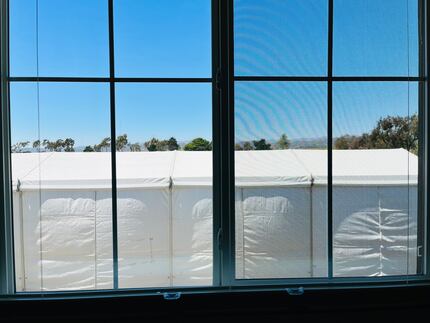 A large tent-like structure blocks Oxnard resident Michelle Payne's second-story view of the...