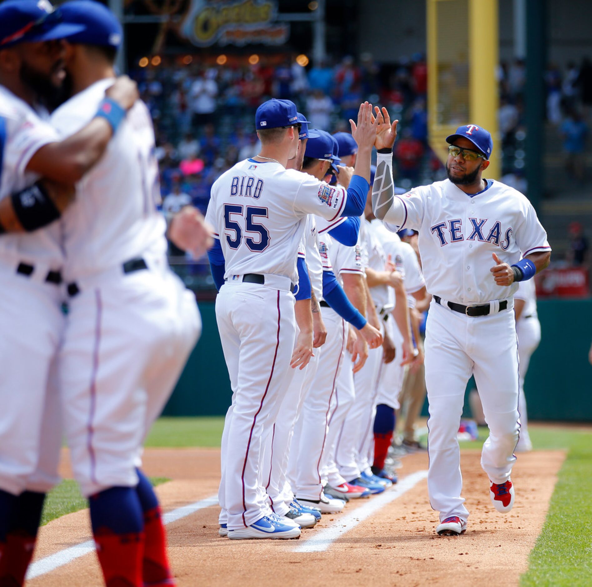 Texas Rangers shortstop Elvis Andrus is greeted by teammate during player introductions on...