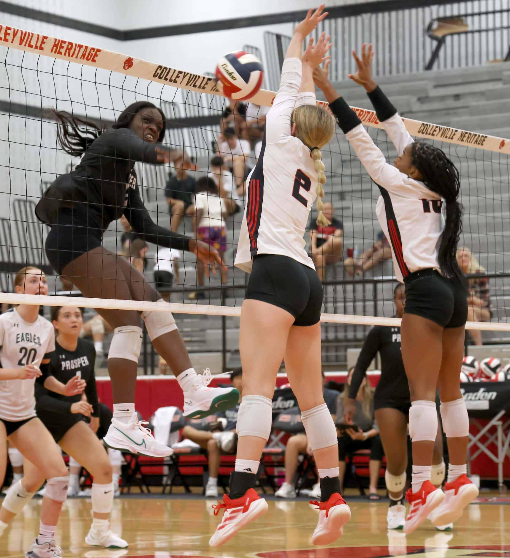 Prosper's Nicole Okojie (14), left, fires a shot against the defense of Colleyville Heritage...